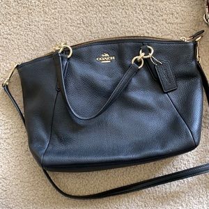 Black coach purse with gold accents.